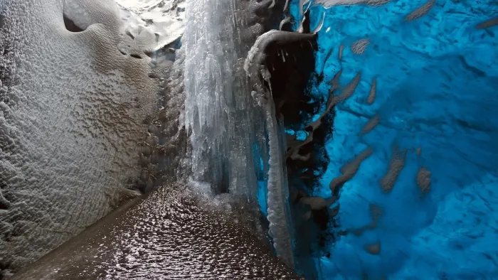 Close-up of frozen volcanic ash formations resembling black sand structures