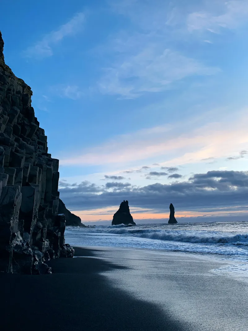 Hexagonal columns of dark volcanic basalt catching golden evening light