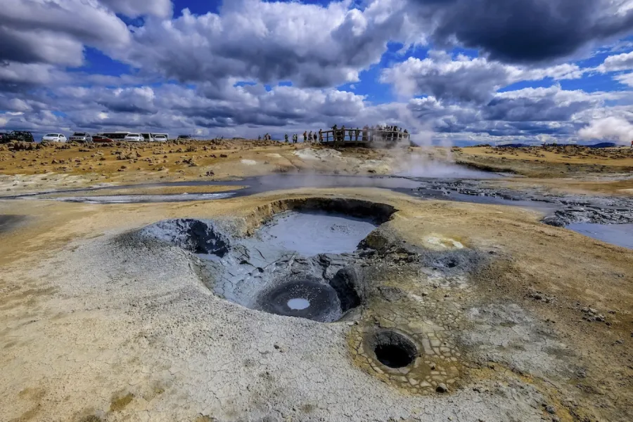 A boiling geothermal mud pot venting thick sulfurous steam in Námafjall