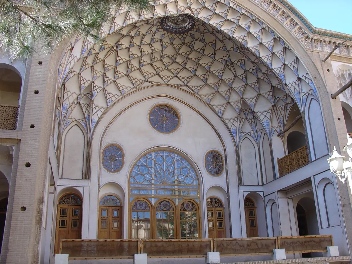 Muqarnas-adorned eyvan courtyard facade at the historic Ameri House in Kashan, Iran